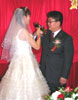 The happy couple toast each other.
