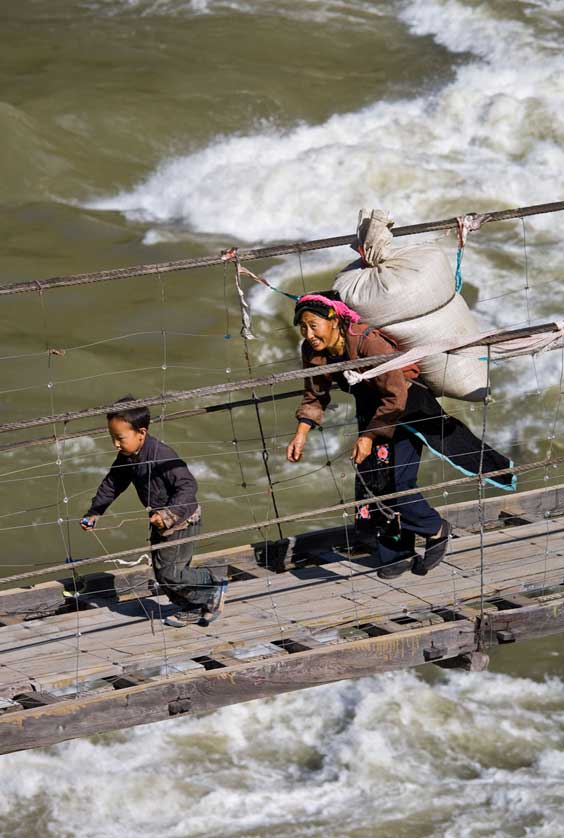 Sichuan Mountain Porter and child in Sichuan Province, China.