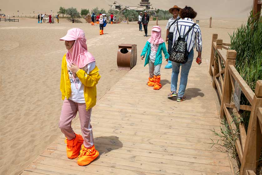 Sun and sand protection at the Echoing Dunes, Dunhuang, China.